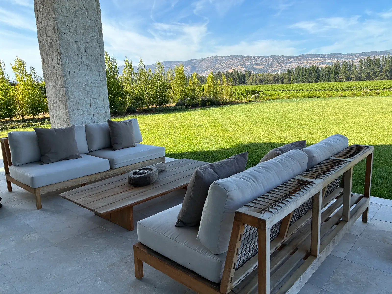 Patio seating overlooking lawn and vineyard views